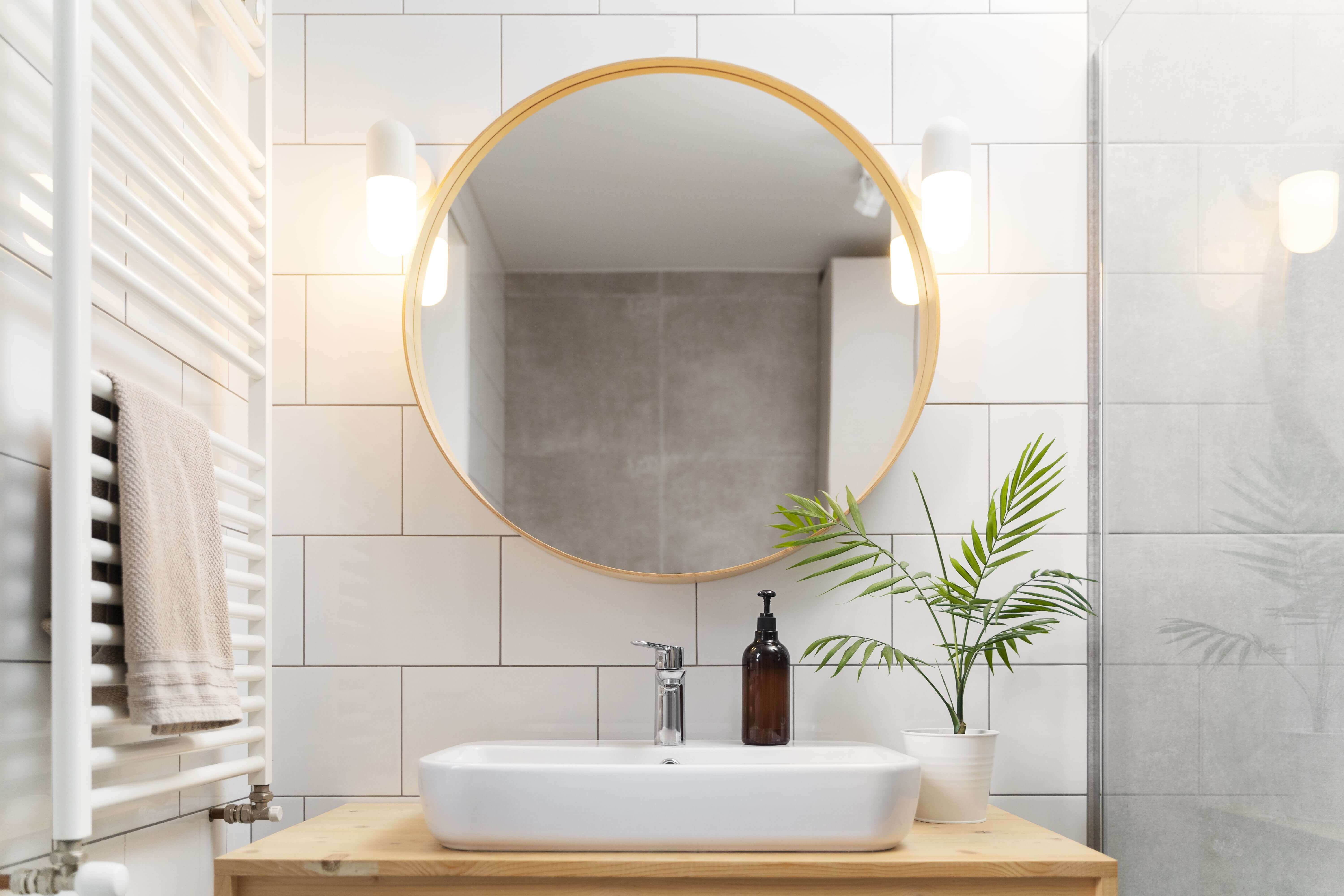 Cozy rustic bathroom with wooden accents and vintage mirror.