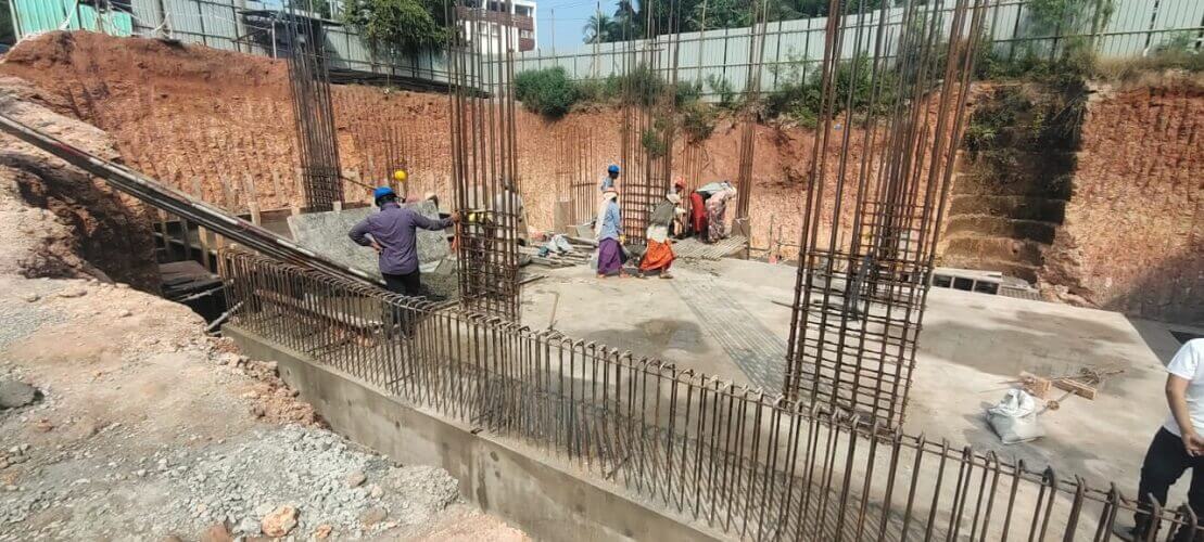 Workers are working on the foundation of Inland Ascott near apartments for sale in bondel church airport.