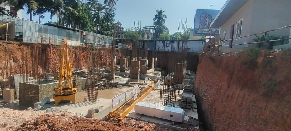 Yellow machinery dug out mud to make way for the foundation.