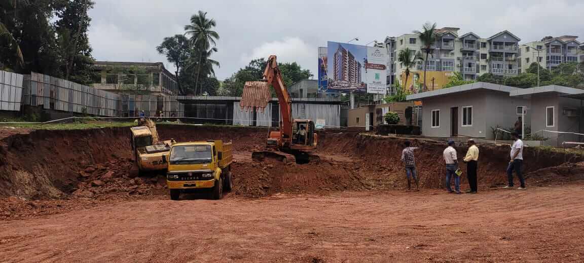 Excavators on site are digging up dirt for the foundation.