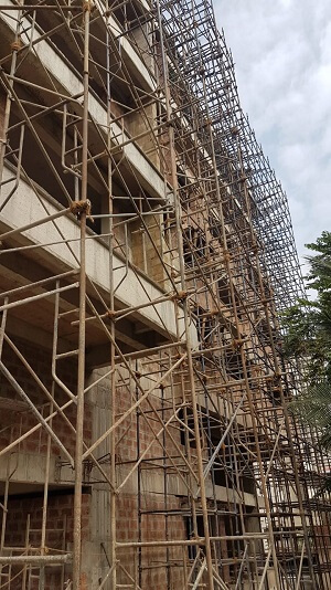 The building is being completed using scaffolding.