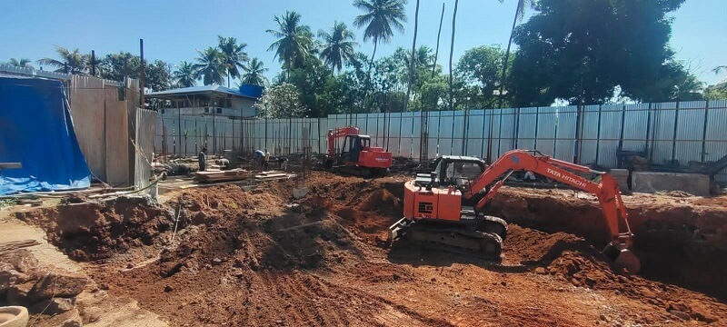 Tata excavator is removing mud to build the foundation.