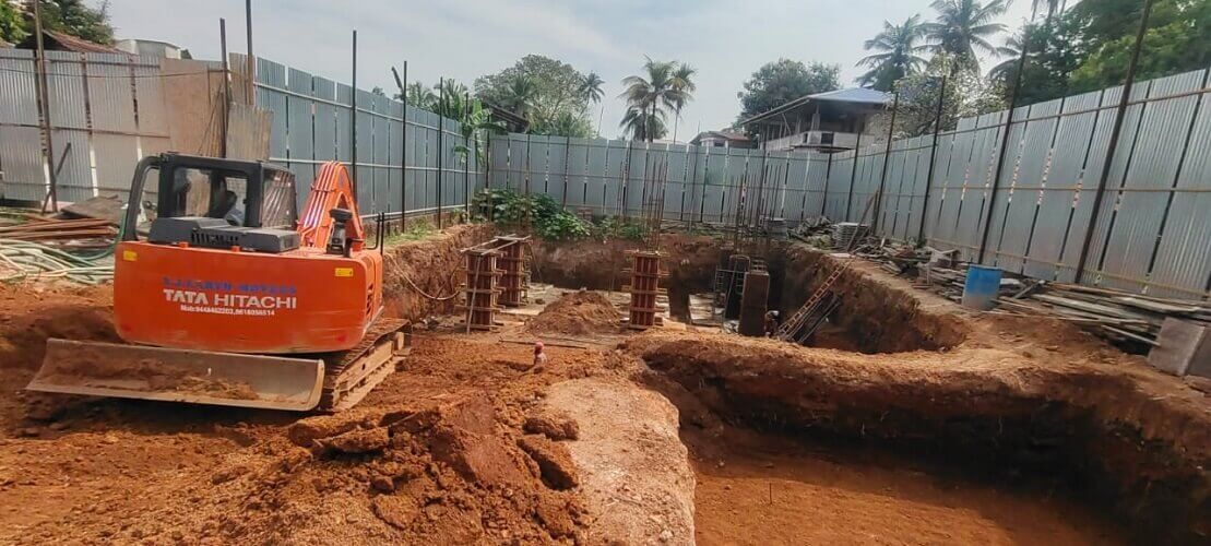 Excavator is digging out mud from the ground.