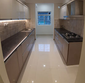 Sleek and minimalist kitchen design with white cabinets and pendant lighting.