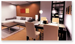 Modern living room with integrated dining area featuring stylish furniture and vibrant decor.