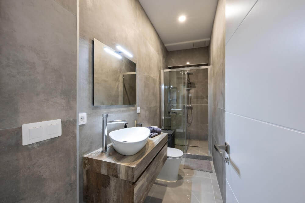 Modern bathroom with sleek fixtures and tile flooring.