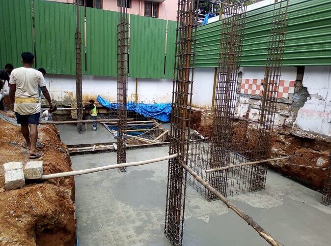 Concrete is poured into the space for the foundation.